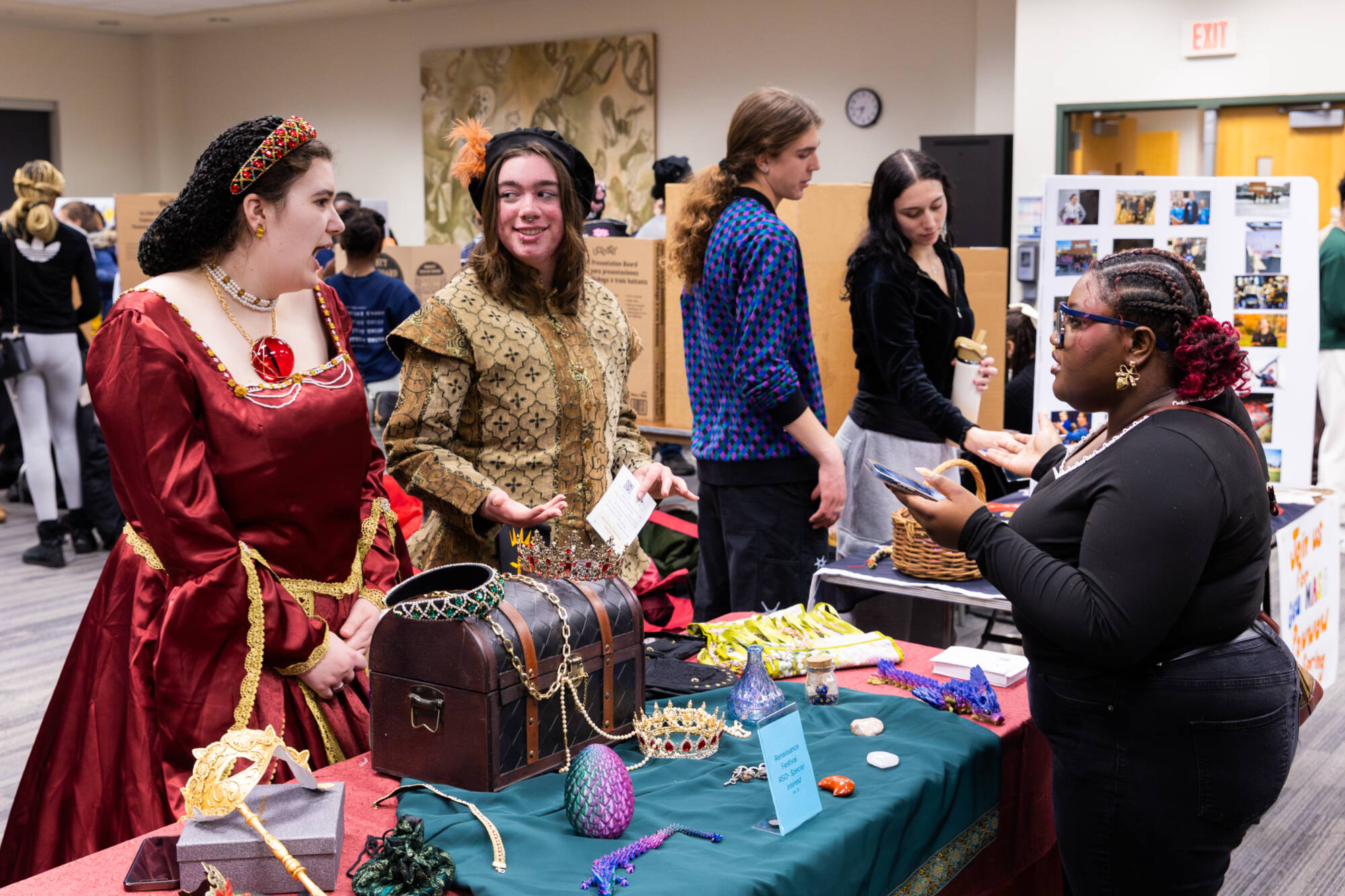 student talking to two students dress for the renaissance festival